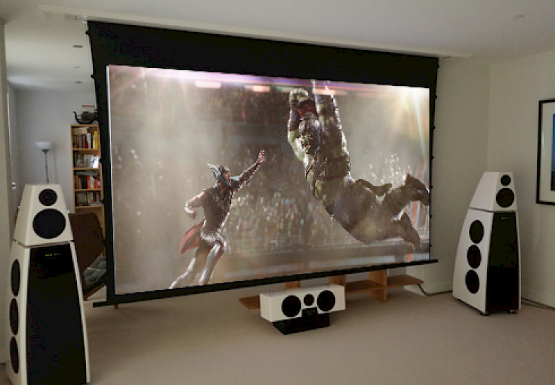 Thor Ragnarok on Meridian Home Cinema with two white dsp speakers either side of the projector screen