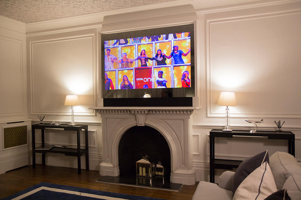 Mirror Frame TV above mantel piece showing Rugby world cup