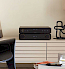 arcam radia a15 and cd5 on sideboard with black wooden chair on the right anf a lamp on the left