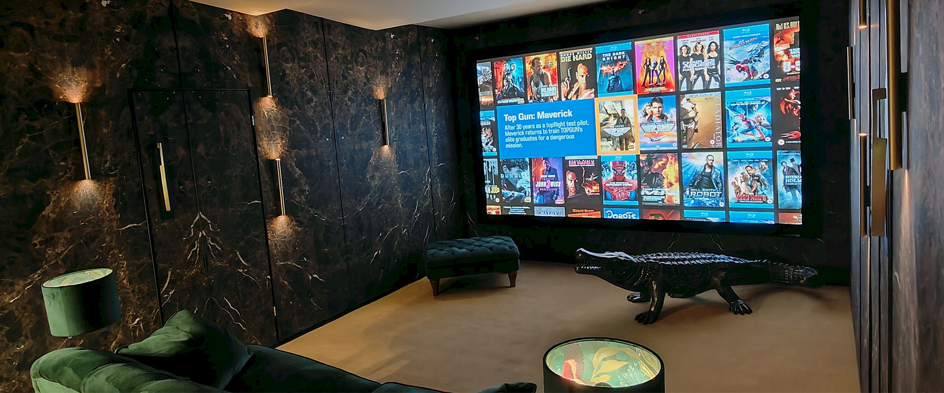 Snug home cinema demo room at martins hifi norwich with a bronze crocodile in front of the cinerma screen